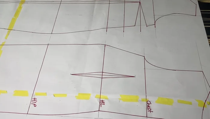 Crease the 1-inch dart on the front block to eliminate the dart on the lower part. Tape it down to secure the crease.