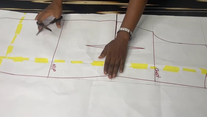 Extend the back pattern by 12 inches at the center back to create a longer back than front. Connect the points smoothly for a curved tail effect.