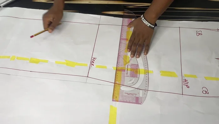 Extend the back pattern by 12 inches at the center back to create a longer back than front. Connect the points smoothly for a curved tail effect.