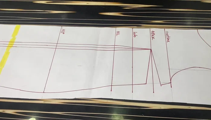 Crease the 1-inch dart on the front block to eliminate the dart on the lower part. Tape it down to secure the crease.