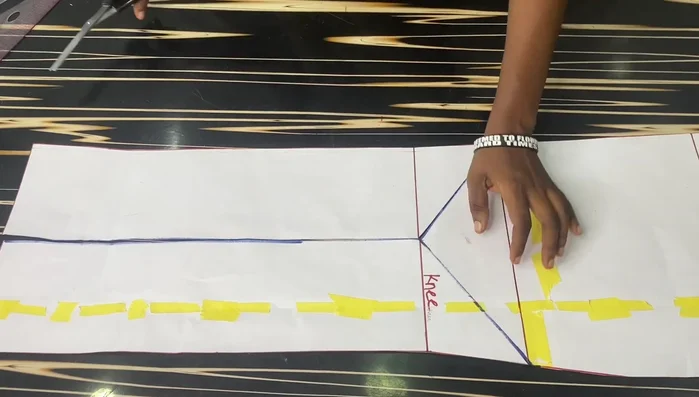 Extend the back pattern by 12 inches at the center back to create a longer back than front. Connect the points smoothly for a curved tail effect.