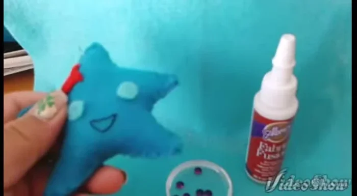 Add embellishments using fabric glue and tweezers (optional). Alternatively, you can sew them on.