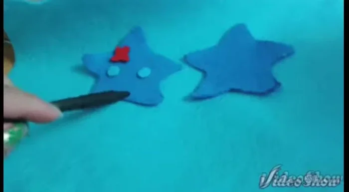 Trace and cut out your starfish template onto felt. Cut two star shapes for the body, two circles for the eyes, and one red flower.