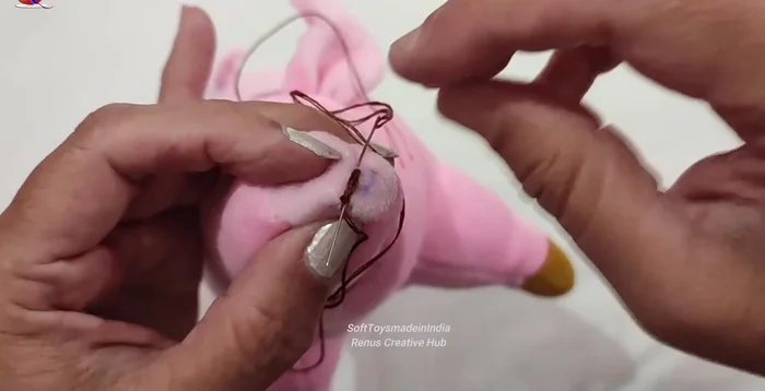 Embroider the nose using straight stitches.