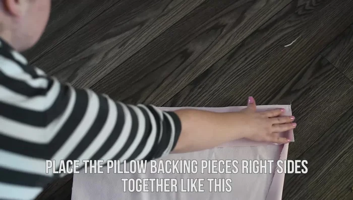 Place the backing fabric pieces right sides together, with the shorter piece on top. Machine stitch only the first and last couple of inches (using a 1/2 inch seam allowance).