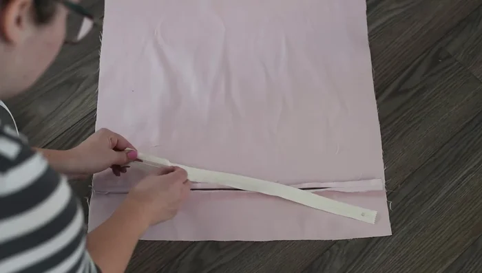 Sew the zipper to both sides of the backing fabric. A zipper foot is helpful but not essential.