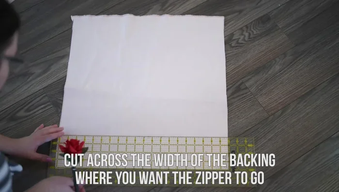 Place the backing fabric pieces right sides together, with the shorter piece on top. Machine stitch only the first and last couple of inches (using a 1/2 inch seam allowance).