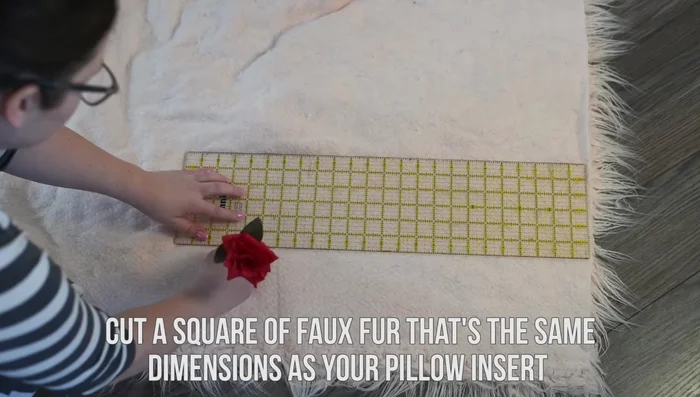 Cut your faux fur fabric to the same dimensions as your pillow insert.