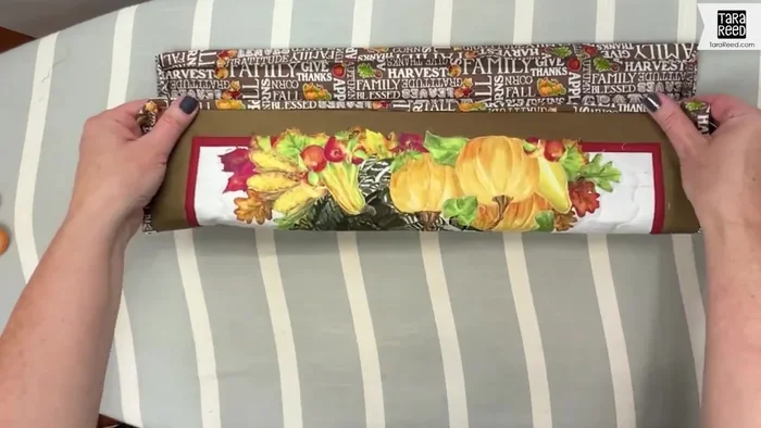 Glue and press the binding: Apply washable school glue to the back of the binding, press it down, and secure with clips to prevent it from lifting while drying.