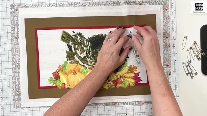 Quilt the layers: Use a sewing machine to quilt the layers together. The tutorial suggests a straight stitch around the outside and inside edges for dimension, followed by free-motion quilting for design.