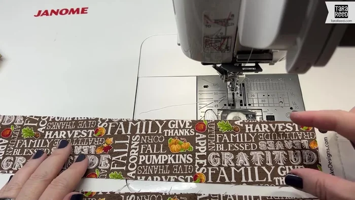 Prepare the binding: Cut four 2 1/2-inch wide strips of your chosen binding fabric. Sew two strips together to create a continuous strip, ensuring the directional print is consistent. Press the seam open. Fold the strip in half lengthwise (wrong sides together) and press again.