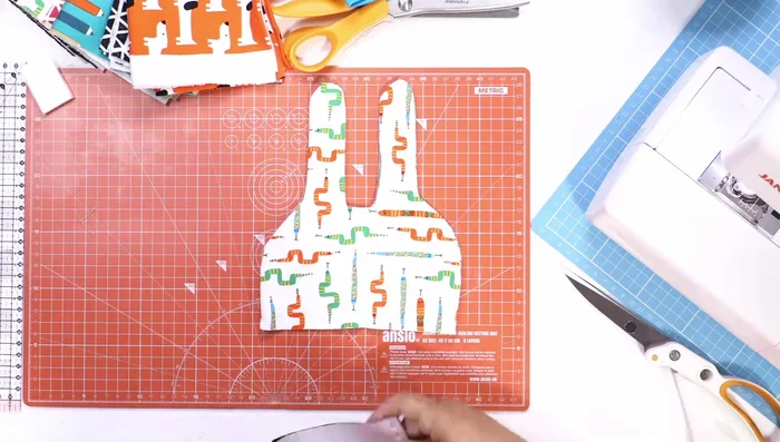 Cut and sew the hat band: Cut a 36cm x 7cm strip of contrasting jersey fabric. Sew the short ends together to form a loop, then attach the band to the hat, right sides facing, with a straight stitch.