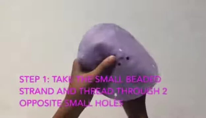 Thread the small beaded strand through two small holes, add a clasp, and pull through.