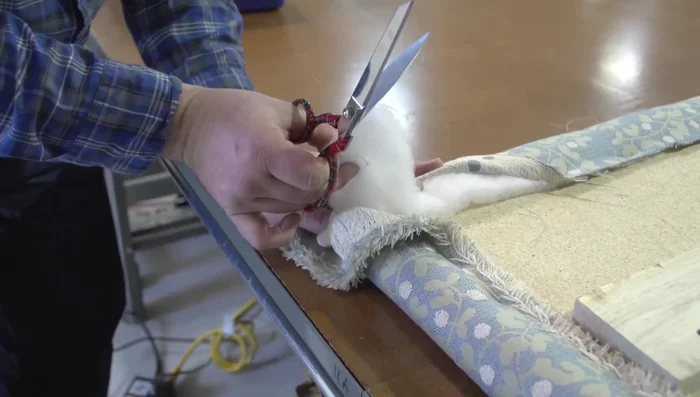 Staple the bottom edge, trimming excess batting and fabric as needed.