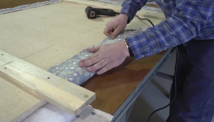 Staple the bottom edge, trimming excess batting and fabric as needed.