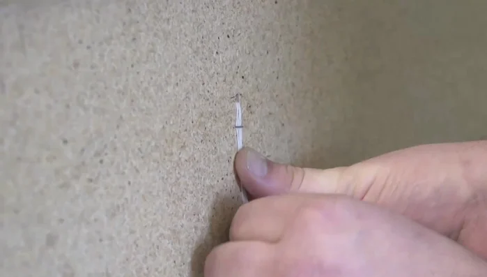 Secure the twine on the back side of the board with staples.