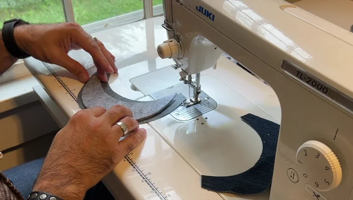 Attach lining sides: Sew the lining sides to the crown, using notches for alignment and a no-pin technique to maintain efficiency.