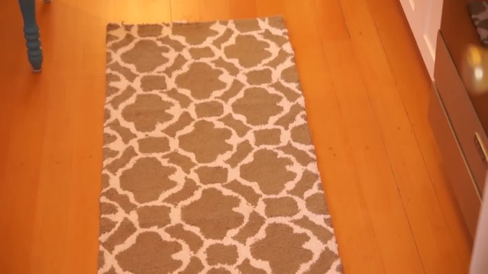 Prepare your materials: Acrylic caulk (not silicone), caulking gun, and the rug you want to make slip-proof.