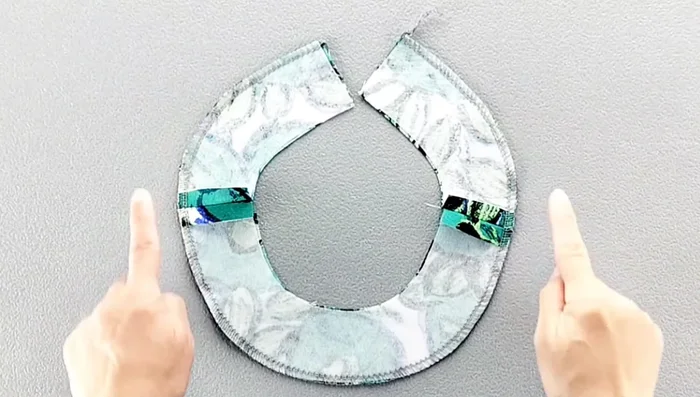 Fold the facing to the right side, pin in place along the neckline, matching shoulder seams, and sew.