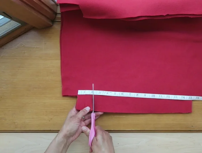 On three sides of each fabric square, make 1-inch cuts along the edge, stopping at the 2-inch corner cuts.