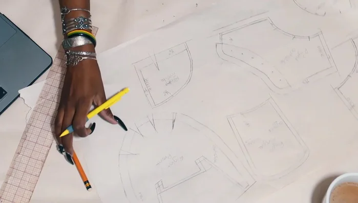 Cut fabric pieces using the pattern, adding seam allowance (though later removed).