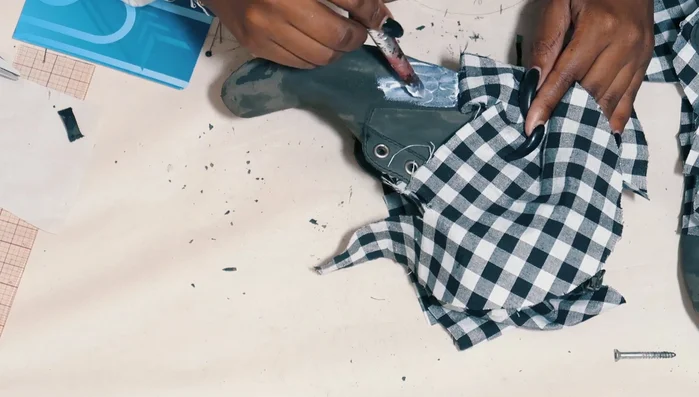 Cut away fabric covering grommets and paint grommet areas black.