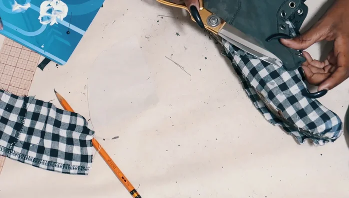 Cut away fabric covering grommets and paint grommet areas black.