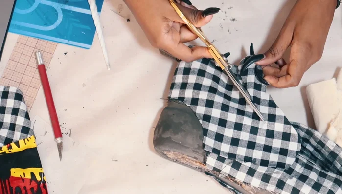 Cut away fabric covering grommets and paint grommet areas black.