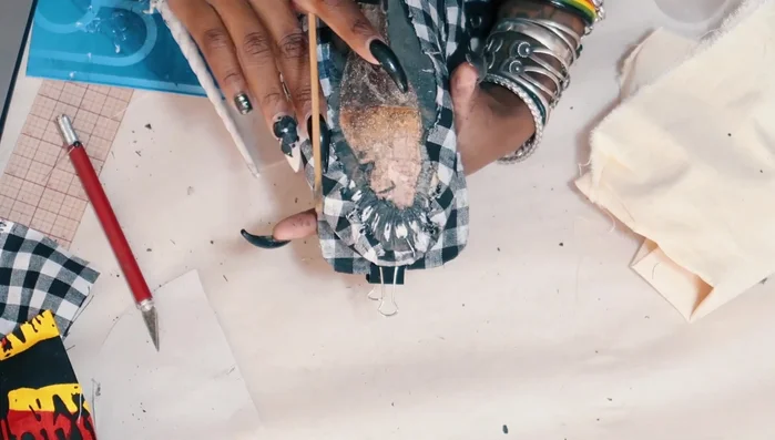 Cover raw edges using strips of fabric from the old dress and other scraps.