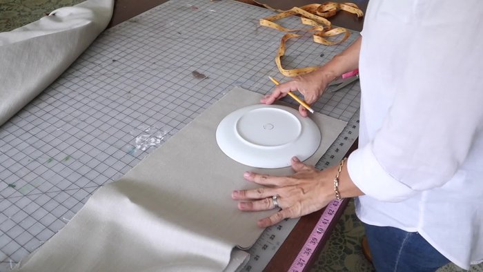 Pin the welt onto the circles, ensuring raw edges align, welt cording is inside, and the welt is positioned correctly.