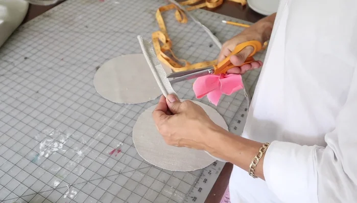 Pin the welt onto the circles, ensuring raw edges align, welt cording is inside, and the welt is positioned correctly.