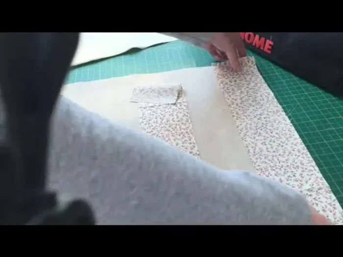 Attach Contrast Trim: Place contrast trim right sides together with main fabric. Sew using a 1/4" seam allowance for the top edge, then a regular straight stitch for the rest. Press seams open and top stitch on either side of the seam.