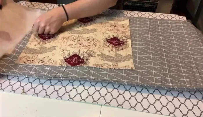 Prepare the interior pockets: Cut openings, sew zippers, and iron.