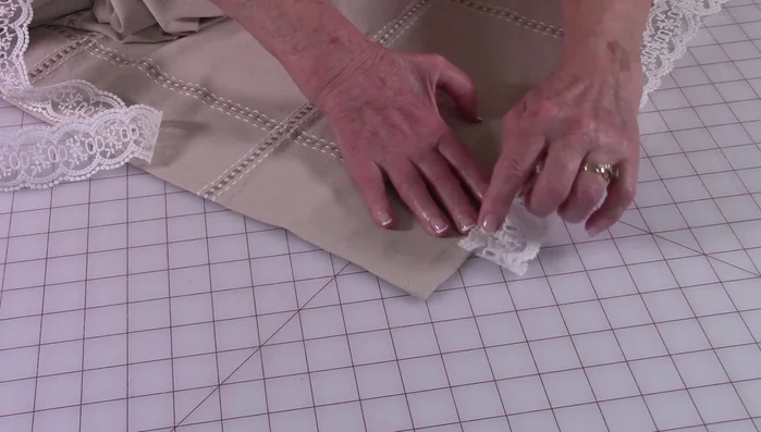 Extend the lace at least three inches beyond the edge on each side for mitered corners.