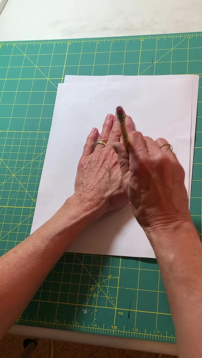 Create a pattern: Trace your hand (or child's hand) onto a piece of paper, leaving about a half-inch seam allowance around the edges and a larger opening at the bottom for your hand.