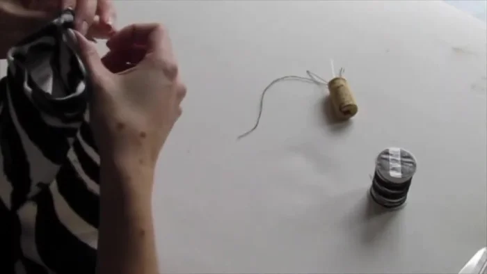 Fold the fabric in half and cut out the pocket shape, ensuring you cut through the seam at the top.