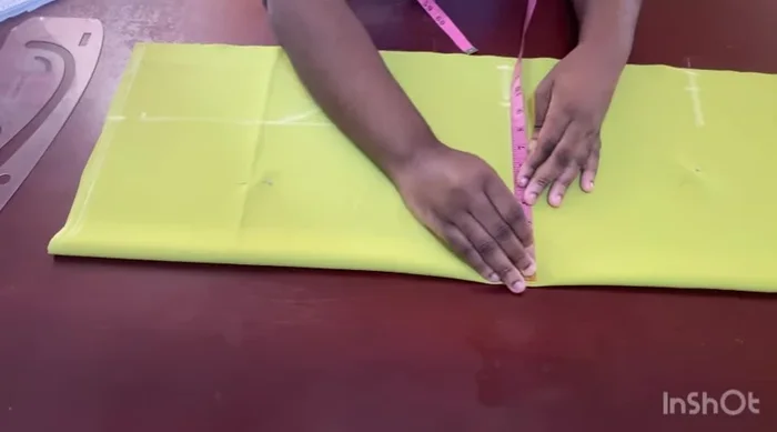 Mark dots for the dart; the top dot reaches the chest line, and the bottom dot stops 2 inches before the hip line.