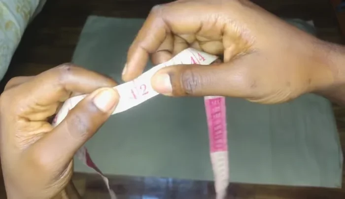 Mark half an inch on either side of the apex line. Connect these points to the lower point in a slightly curved line, creating the basic skirt shape.