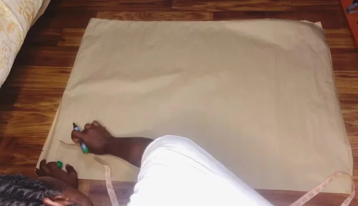 Mark half an inch on either side of the apex line. Connect these points to the lower point in a slightly curved line, creating the basic skirt shape.