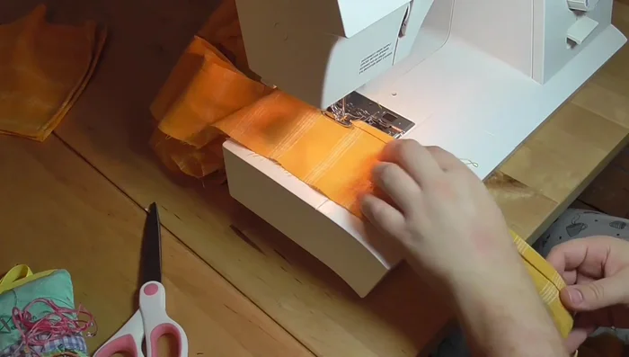 Gather and attach the ruffle to the skirt hem. Finish with bias tape or hand-stitching.