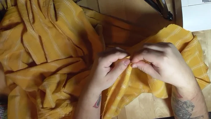 Gather and attach the ruffle to the skirt hem. Finish with bias tape or hand-stitching.