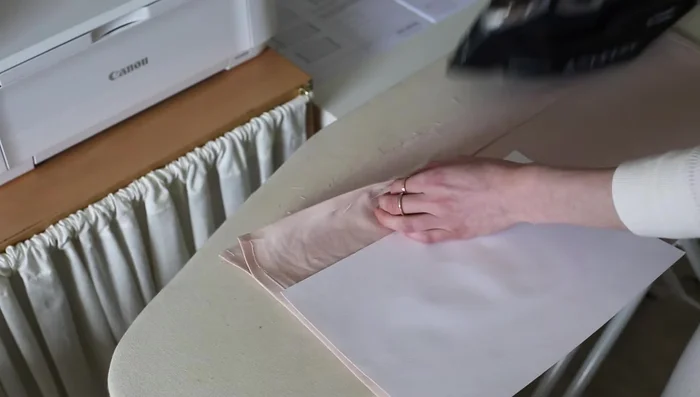 Create the channel seam for the drawstring by folding and pressing the top edge of the drawstring panel twice, then stitch all the way around.