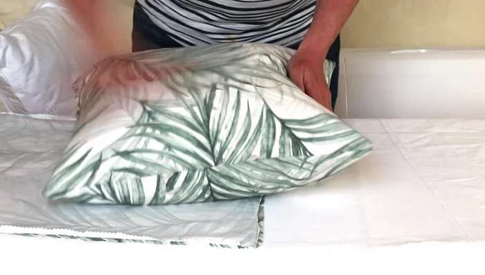 Close the zipper and plump the pillow.