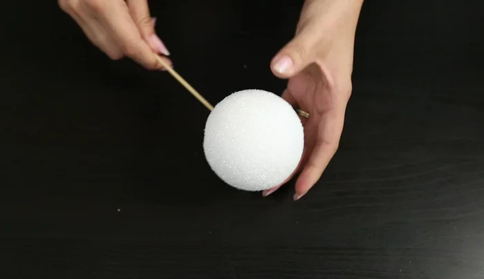 Stick skewers halfway into the Styrofoam ball.