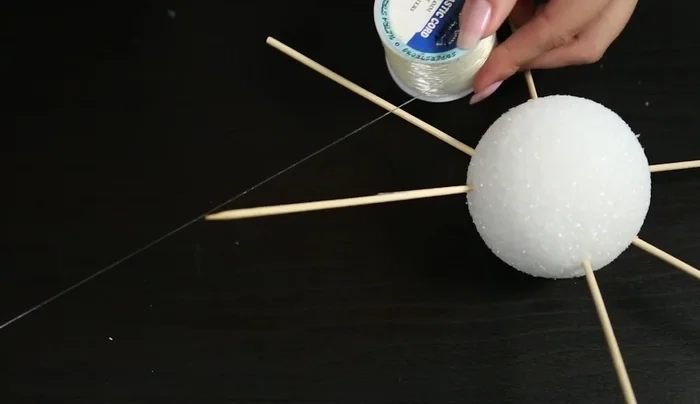 Prepare beading strings: Attach a crimp bead to one end of the beading wire, add teardrop beads, and crimp another bead at the other end to secure them. Create multiple strings of varying lengths.