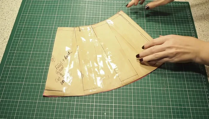 Prepare the peplum: Cut out two peplum pieces, sew the side seams, and finish the hem in the same way as the sleeves.