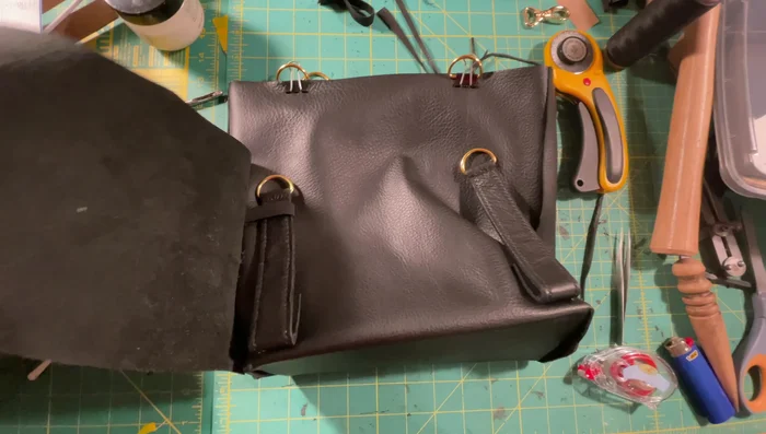 Create luggage flap: Sew the luggage flap, optionally adding a liner for stiffness and a curve accentuation.