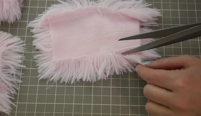 Trim ½ inch of fur from the edges of the fabric pieces before sewing to create a cleaner seam.