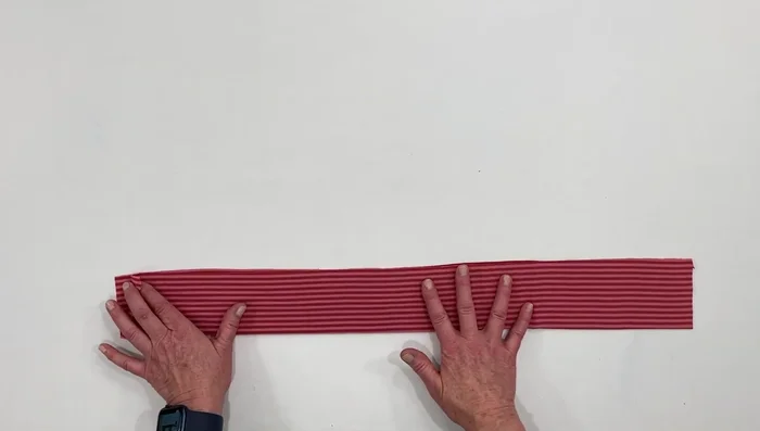 Sew along the top edge using a sewing machine or serger (zigzag or serger stitch recommended).