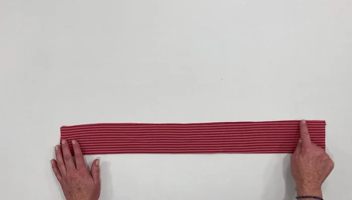 Sew along the top edge using a sewing machine or serger (zigzag or serger stitch recommended).